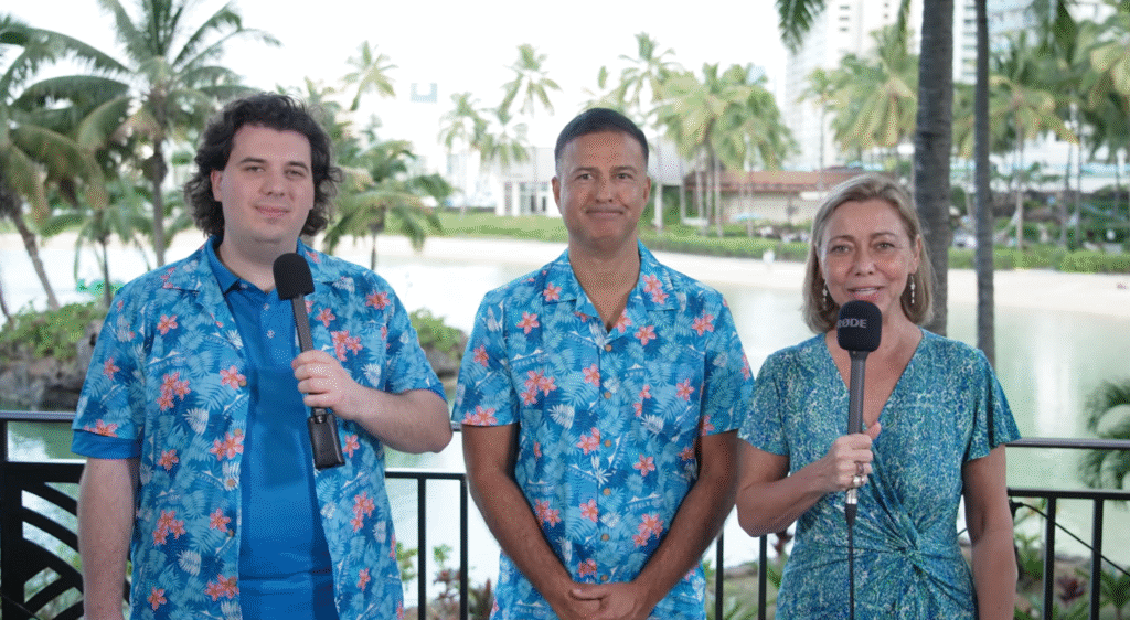 Alex, Eric and Isabelle standing in front of the beach in Hawaii
